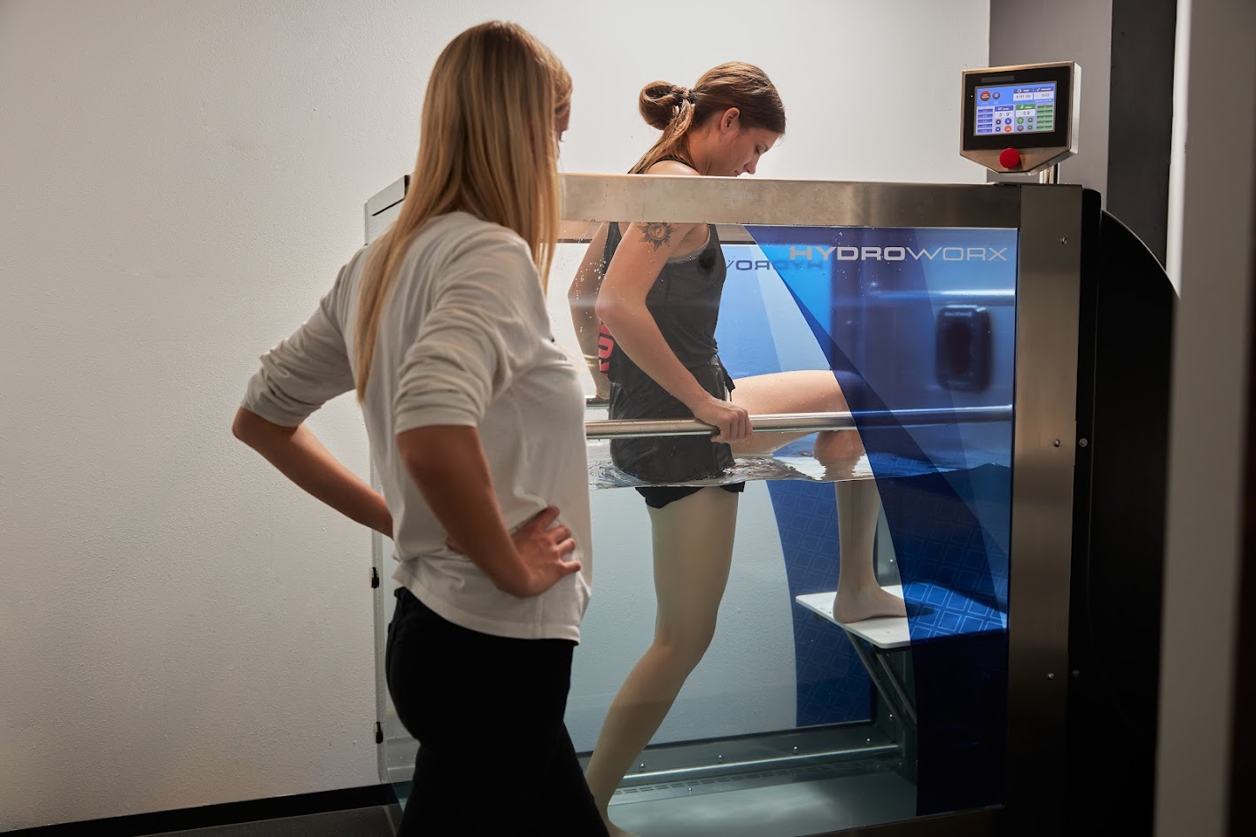 Julia Nelson, DPT, assists a young woman using aquatic therapy chamber at North Born Physical Therapy in Thief River Falls, MN.